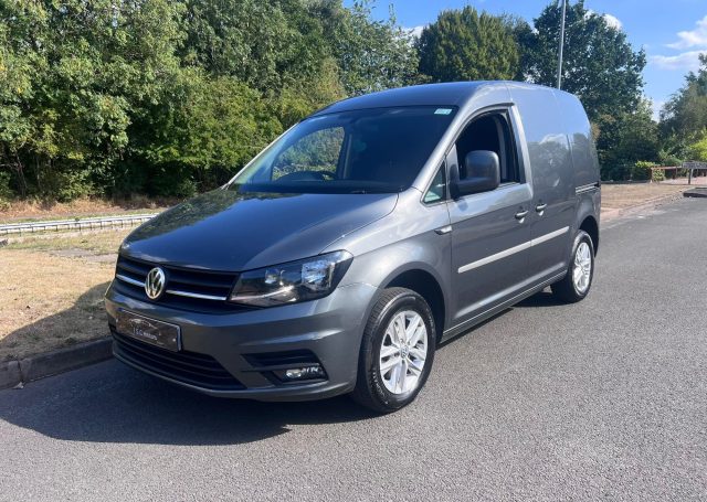 Grey VW Caddy Van parked on a quiet road.