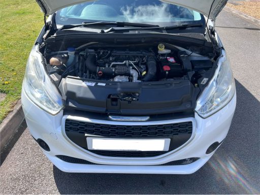 White car with its bonnet open, revealing the engine compartment.
